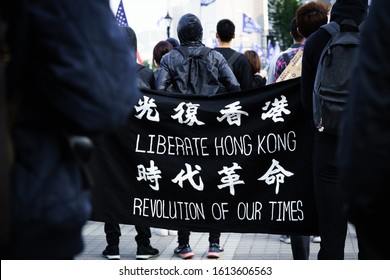 HONG KONG - JANUARY 12 2020: A protestor displays a pro-democracy flag on their back at the  'Universal Siege on Communists' Pre-March Assembly in central Hong Kong.