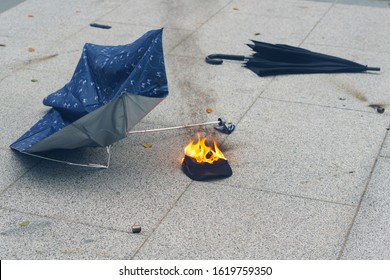HONG KONG - JANUARY 19 2020: A protester's hat catches fire after riot police shot tear gas at a crowd to disperse them during the 'Universal Siege on Communists' rally at Chater Garden, Hong Kong.