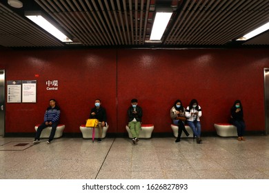 Hong Kong - January 27, 2020: Passengers Of The MTR Patiently Wait For The Subway As They Play With Their Phones, Wearing Face Masks Following Reports Of The Wuhan Coronavirus Appearing In Hong Kong.