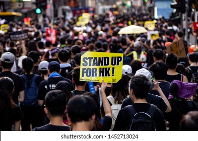 HONG KONG - JULY 1 2019: Hong Kong people holding signage/poster of "Stand Up For HK" to appeal to during a protest against the Extradition Bills on the 22nd Handover Anniversary Day.