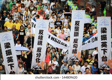 HONG KONG - JULY 1: The Hong Kong 1 July Protests In Hong Kong On 1 July 2013. The Protesters Request The Political Reform, The Economic Crisis And The Solution Of Housing Problem