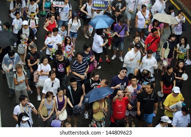 HONG KONG - JULY 1: The Hong Kong 1 July Protests In Hong Kong On 1 July 2013. The Protesters Request The Political Reform, The Economic Crisis And The Solution Of Housing Problem