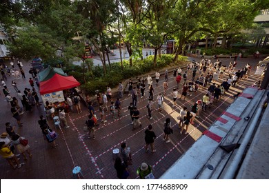 HONG KONG - JULY 12 2020: People Line Up To Vote. The Pro-democratic Camp Holds A Primary To Prepare For The Legislative Council Election, Over 610000 Residents Cast Their Vote. 