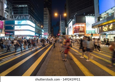 HONG KONG, HONG KONG - JULY 2019 : Crowd Unrecognizable Pedestrians Walking And Traffic Car Over The Crosswalk In Mong Kok Area On July 6, 2019, Hong Kong,Famous Market Of Shopping Center At Nightlife