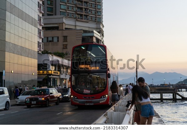 Hong Kong - July 23, 2022: An out of service red\
bus namely Heartbeat of the City of Kowloon Motor Bus passes\
through Belcher Bay Promenade, the destination sign says thank you\
for fighting covid19