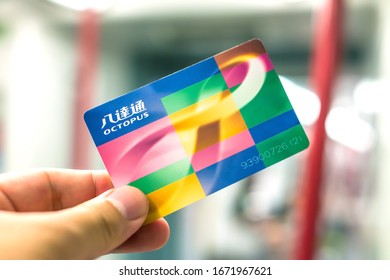 Hong Kong - June 5, 2015 : Octopus Reusable Contactless Stored Value Smart Card In Hand, Inside MTR Train In Hong Kong
