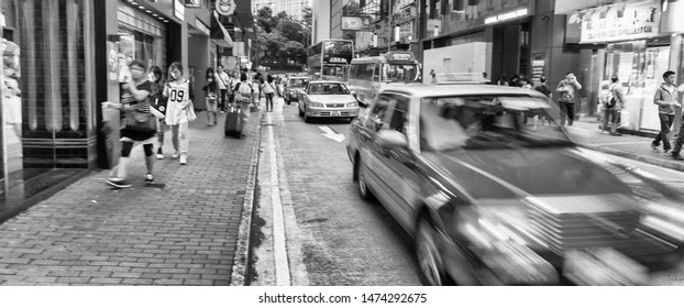 HONG KONG - MAY 10, 2014: City Traffic With Cars And Taxis. Hong Kong Hosts 10 Million Tourists Every Year.