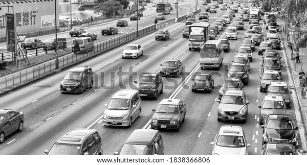 HONG KONG - MAY 10,\
2014: City traffic with cars and taxis. Hong Kong hosts 10 million\
tourists every year.