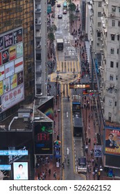 HONG KONG - May 20: A busy street on May 20, 2016 in Hong Kong. With a land mass of 1,104 km2 and a population of 7 million people Hong Kong is one of the most densely populated areas in the world - Shutterstock ID 526262152
