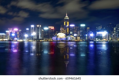 Hong Kong Night Building Skyline With Motion Clouds And Reflection Of Light