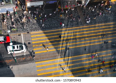 Hong Kong - October 5, 2019: Aerial View Of People Walking On The Street Side And Crossing The Street.