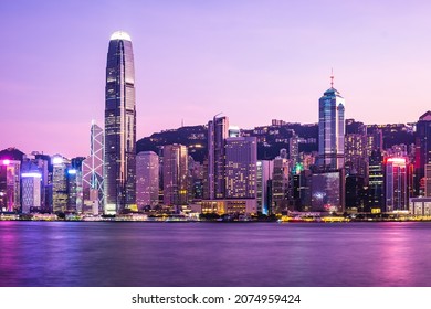 Hong Kong skyline cityscape downtown skyscrapers over Victoria Harbour in the dusk. - Shutterstock ID 2074959424