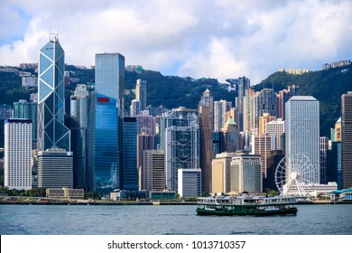 Hong Kong Skyline And Passenger Ferry Transportation On Victoria Harbor At Sunrise Morning