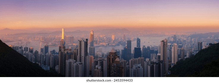 Hong Kong skyline at sunset, with a beautiful view of the Central CBD, Victoria Harbour, Kowloon cityscape, Hong Kong, China, Asia - Powered by Shutterstock