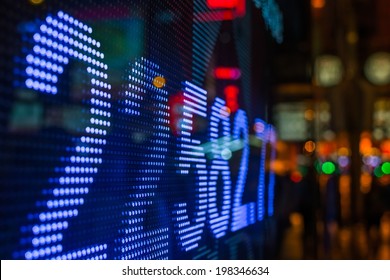 Hong Kong stock market price display at street in the night.
