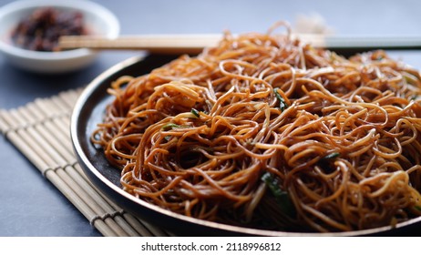 Hong Kong Style Plain Fried Noodles On A Black Plate. Chinese Food.