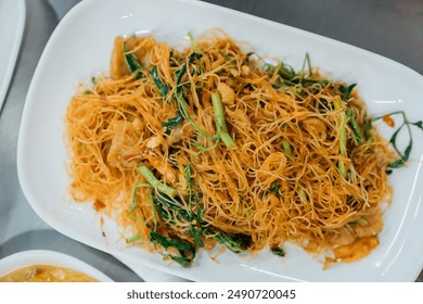 Hong Kong style stir fried noodles are cooked with high heat flames Pad Thai is a popular Thai street food made with fried rice noodles - Powered by Shutterstock