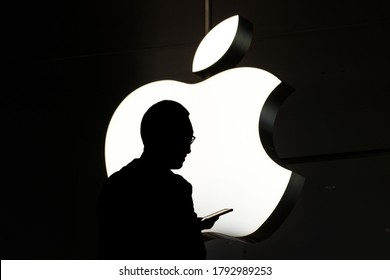 HongKong - November,  2019: Silhouette Of A Person Using Mobile Phone In Front Of The Apple Logo 