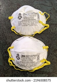 Honolulu - August 1, 2020: Two White N95 Face Masks With Yellow Ear Straps Made By 3M On Floor.