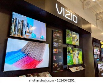 Honolulu -  August 10 2018:  Vizio TV Display With Paint Brush And Dog Shaking On Screens Inside Best Buy.  VIZIO Is The Maker Of The Top-selling 4K HDR TVs And America's #1 Sound Bar Brand.