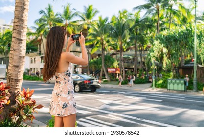 Honolulu City Woman Tourist Taking Pictures With Phone Camera Walking On Street In Waikiki, Oahu, Hawaii. USA Summer Travel.