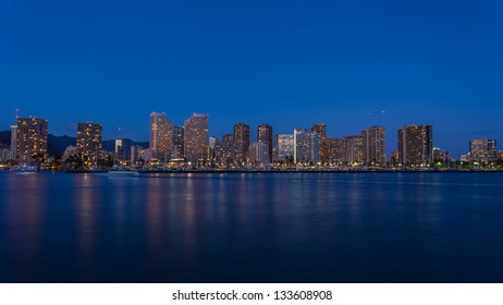Honolulu downtown at night with seafront