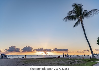 Honolulu, Hawaii - circa February 2022: People enjoy the sunset at Ala Moana Beach Park.