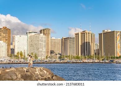 Honolulu, Hawaii - circa February 2022: People enjoy a relaxing day, overlooking Ala Moana Beach Park and harbor.