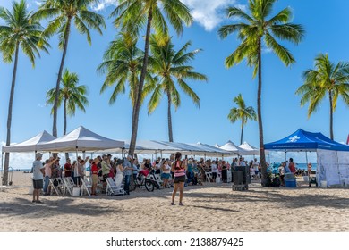 Honolulu, Hawaii - circa February 2022: A woman views a church service on the beach at Waikiki.