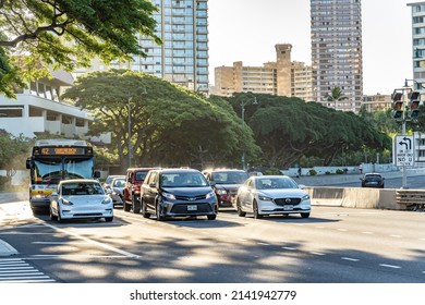 Honolulu, Hawaii - circa February 2022: A bus stopped at a stop light downtown, near the Ala Moana park.