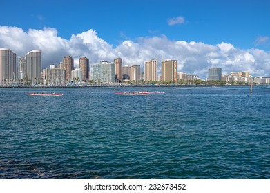 Honolulu, Hawaii, June 4, 2014:  Outrigger canoe race with the Hilton Rainbow Tower and Waikiki hotels in the background.