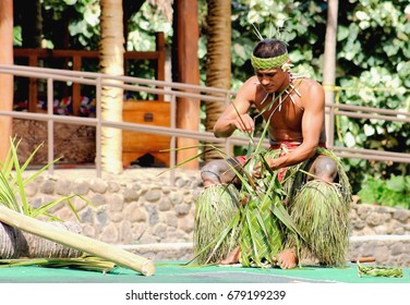 Honolulu, Hawaii - May 27, 2016:A young Samoan man demonstrating the art of weaving in the Village of Samoa at the Polynesian Cultural Center.