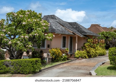 Honolulu, Hawaii, USA.  August 10, 2022.  Restored Row Of 1920 Bungalows With A Plumeria Tree In For Foreground.