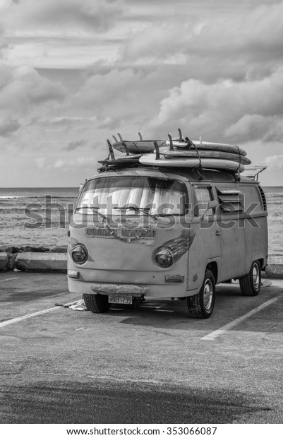 Honolulu, Hawaii,\
USA, Dec. 19, 2015:  Shore side  view of a vintage surfing van with\
six surfboards on top.  Vintage transportation is a popular choice\
with Waikiki surfers.