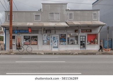 Honolulu, Hawaii, USA, Feb. 17, 2017:  Honolulu Street Photograph Of A 1900's  Gray And White Building With Active Business Below The Owner's Home.