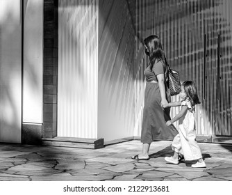 Honolulu, Hawaii, USA.  February 14, 2022.  Masked mother and daughter shopping at Ala Moana Center, for use as a public service ad or message.
