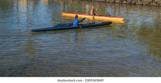 Honolulu, Hawaii, USA, Jan. 24, 2018.  Polynesian Couple Exchange Greetings From Their One Person Outrigger Canoes.