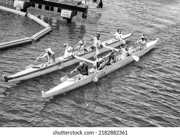Honolulu, Hawaii, USA.  July 26,  2022.  Double outrigger canoe and a team of paddlers racing through the Ala Wai Canal.