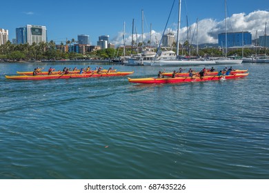 Honolulu, Hawaii, USA, July 31, 2017:  Hawaiian high school teams practicing paddling in traditional outrigger canoes at the Ala Wai Harbor.