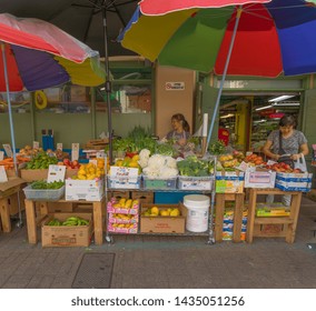 Honolulu, Hawaii, USA.  June 26, 2019.  Female Shop Owner In Chinatown With The Freshest Fruits And Vegetables.