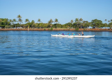 Honolulu, Hawaii, USA, June 27, 2015: Waikiki Outrigger Canoe Team With Their Coach Standing Up To Critique Her Team.  Outrigger Canoe Racing Is A Popular Sport In Hawaii.