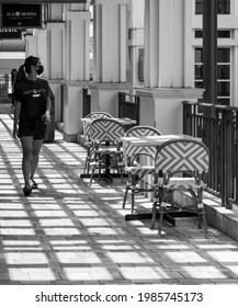 Honolulu, Hawaii, USA.  June 4,    2021.  Young woman shopping at Ala Moana Center in sunlight and shadows.