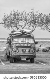 Honolulu, Hawaii, USA, March 1, 2017:  Vintage Surf Van Parked At Waikiki With A Quiver Of Surfboards Atop The Roof.