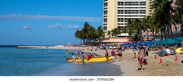 Honolulu, Hawaii, USA.  March 20, 2021.  Tourists boarding an outrigger canoe  in Waikiki as hotels reopen after the corona virus pandemic.