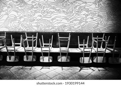 Honolulu, Hawaii, USA.  March 5, 2021.  Stacked Chairs On Tables In An Empty Closed Restaurant.