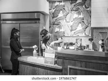 Honolulu, Hawaii, USA.  May 20,  2021.  Coffee barrister and assistant brewing freshly ground coffee at Ala Moana Shopping Center.