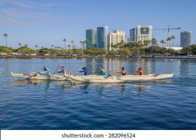 Honolulu, Hawaii, USA, May 30, 2015: Women's outrigger canoe crew practices for the Summer Outrigger Canoe Regatta in Waikiki. Female canoe paddlers are a popular sport throughout the Pacific Islands.