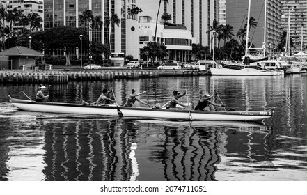 Honolulu, Hawaii, USA.  November 15, 2021.   Hawaiian outrigger canoe  and paddlers racing through the Ala Wai Channel in Waikiki.