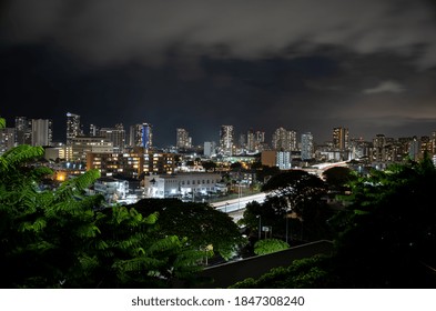 Honolulu, Hawaii, USA.  November 4, 2020.  City Lights And Evening Rain Showers Over Downtown And The Crowded H-1 Freeway.