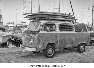 Honolulu, Hawaii, USA, Oct. 20, 2016: Black and white view of an old VW surfing van next to the ocean in Waikiki.